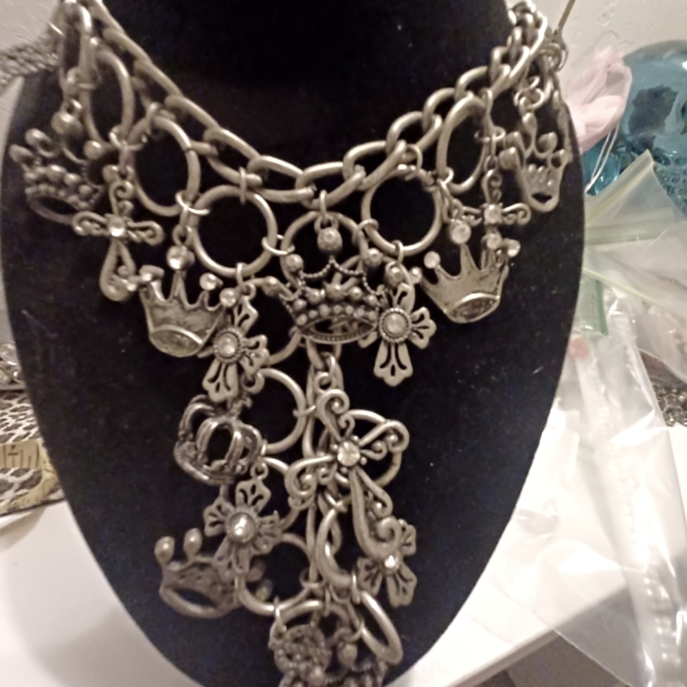 Brilliant bib style featuring crowns and crosses